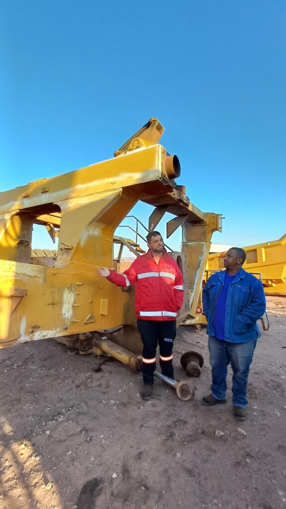 Red Earth NDT founders discussing equipment on-site in mining environment